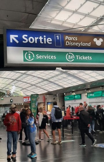 At the train station. A Sign for the Disneyland Paris Parks