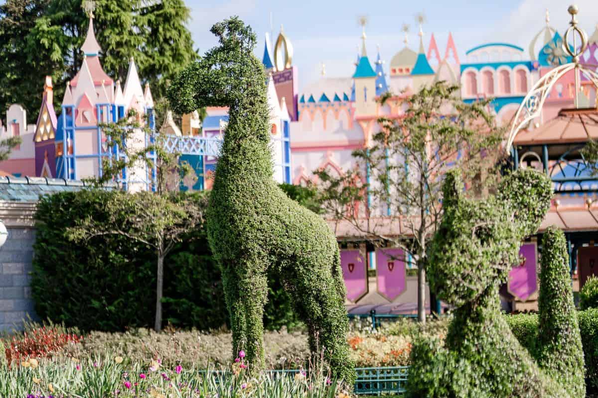 Topiary figures in Fantasyland. Summer is a great time to go when planning a Disneyland Paris trip.